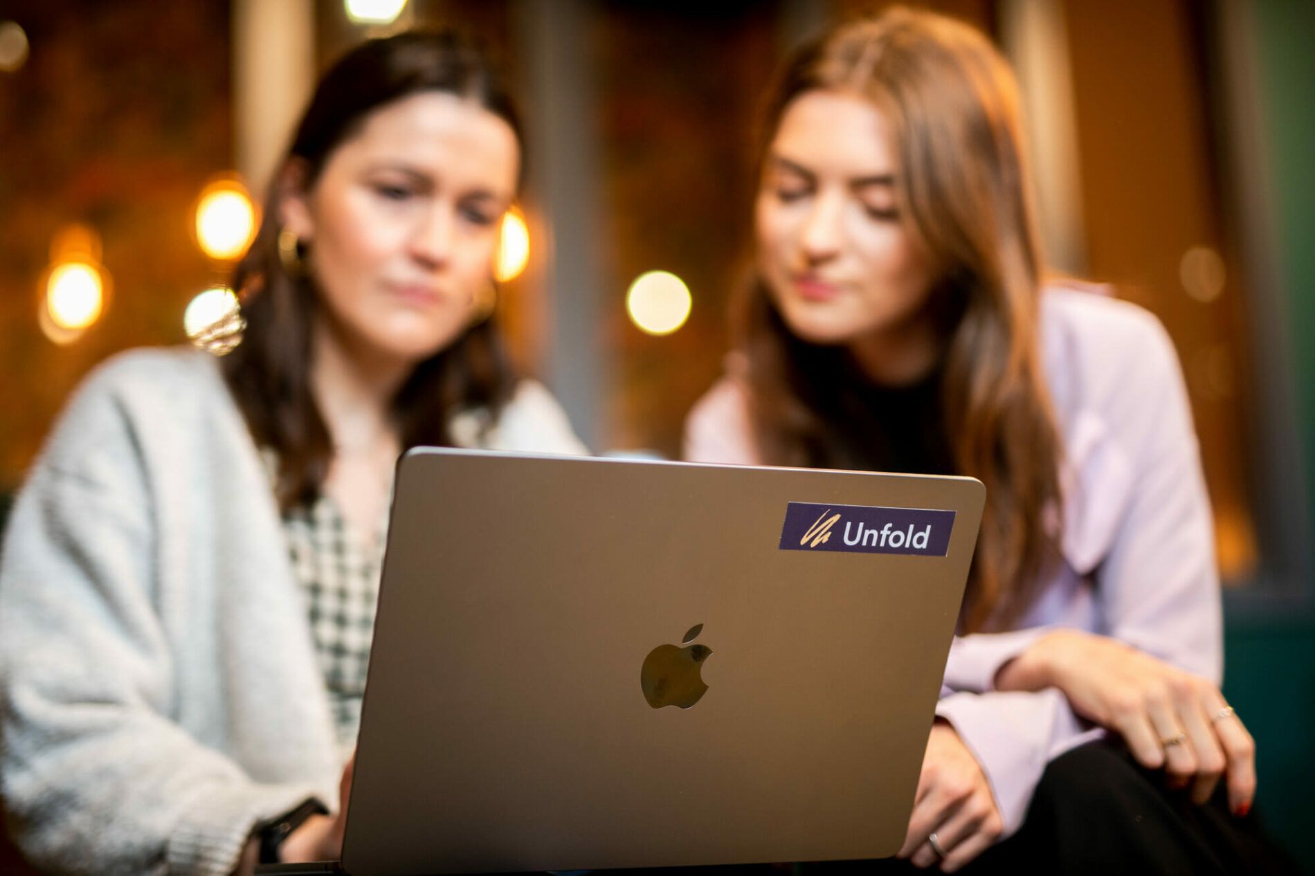 Unfold's Digital Marketing Manager and UX design lead looking at a laptop
